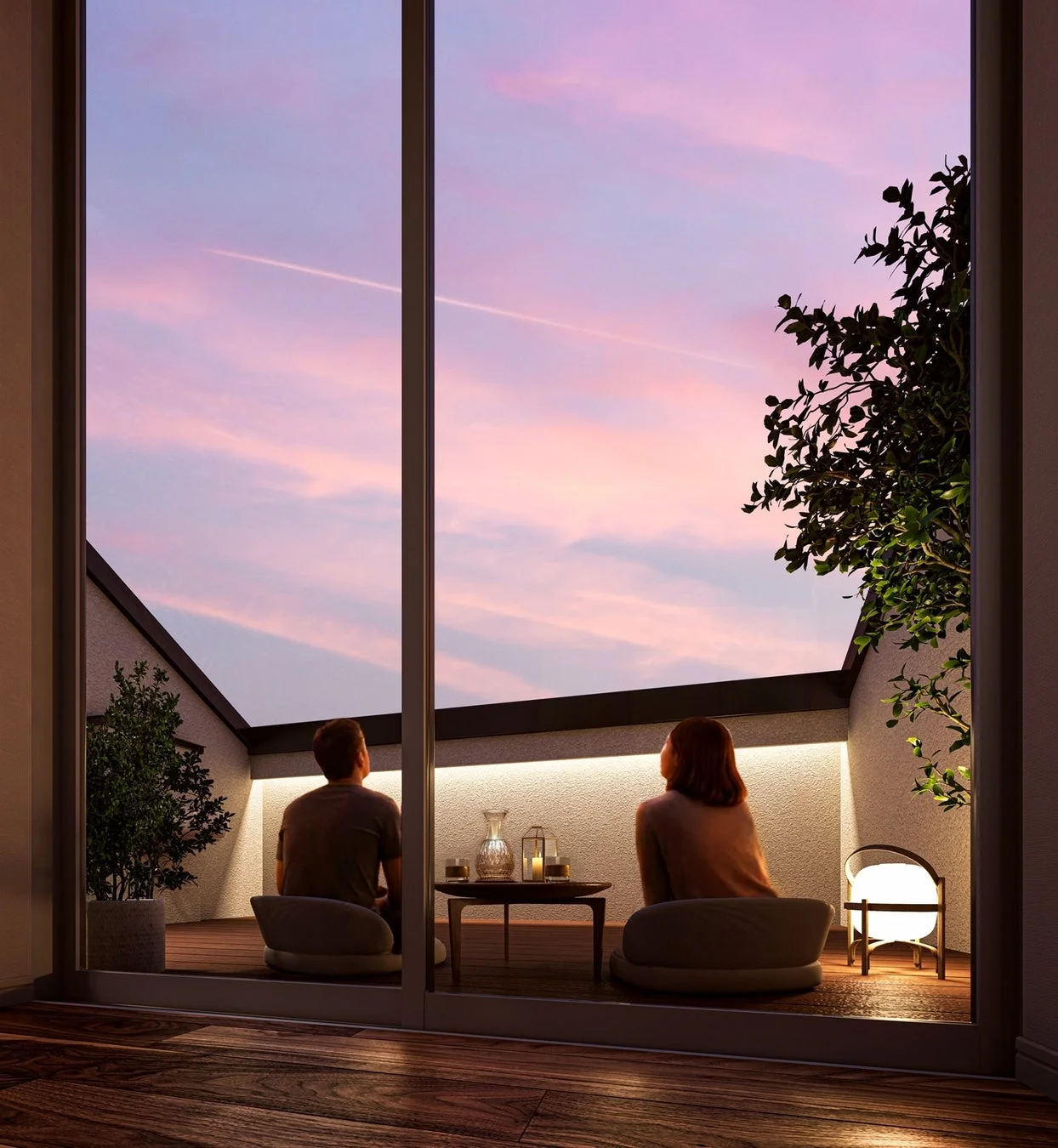 夕焼け空が広がるバルコニーで、カップルがくつろいでいる様子。ピンクと紫に染まる空の下、柔らかな照明がロマンチックな雰囲気を演出し、穏やかな時間を過ごす二人の姿が印象的です。