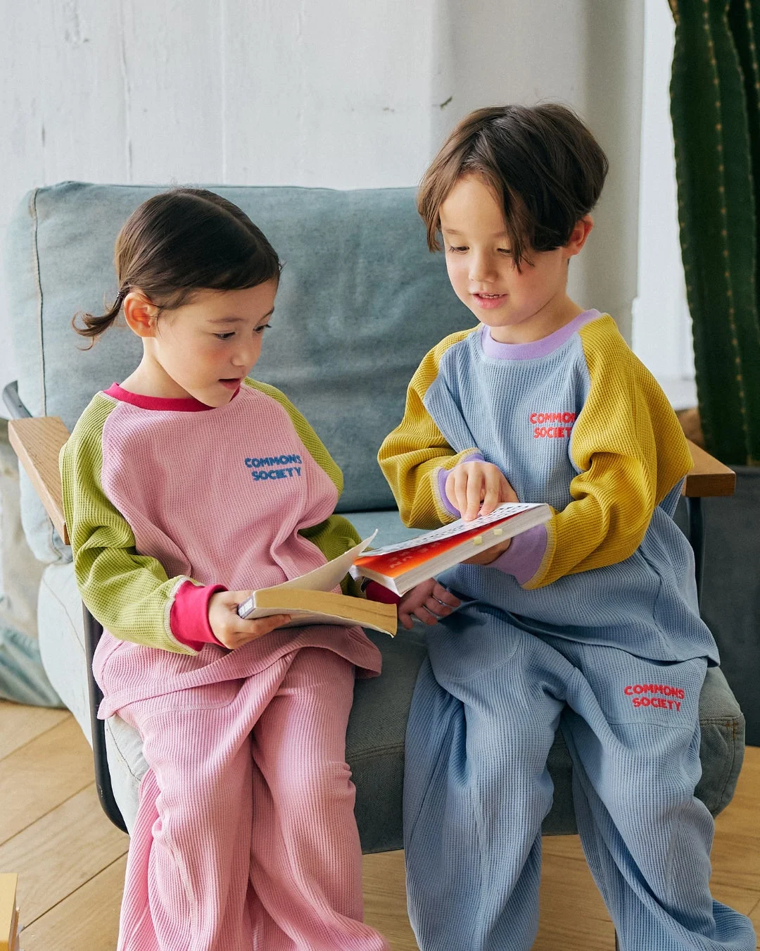 ワッフル生地の服を着て本を読む子供たち